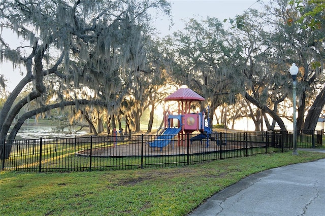 community playground with a yard and fence