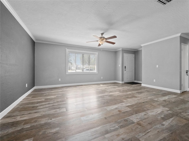 unfurnished room with ceiling fan, wood finished floors, and ornamental molding