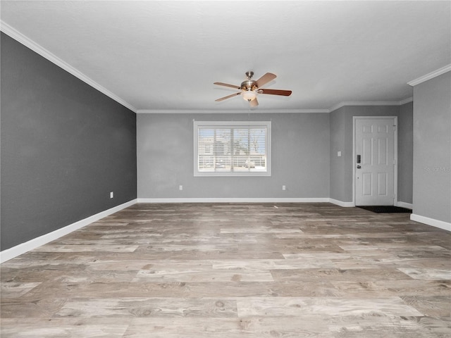 spare room with ornamental molding, a ceiling fan, and wood finished floors