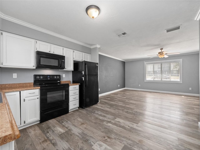 kitchen featuring wood finished floors, visible vents, a ceiling fan, black appliances, and white cabinetry