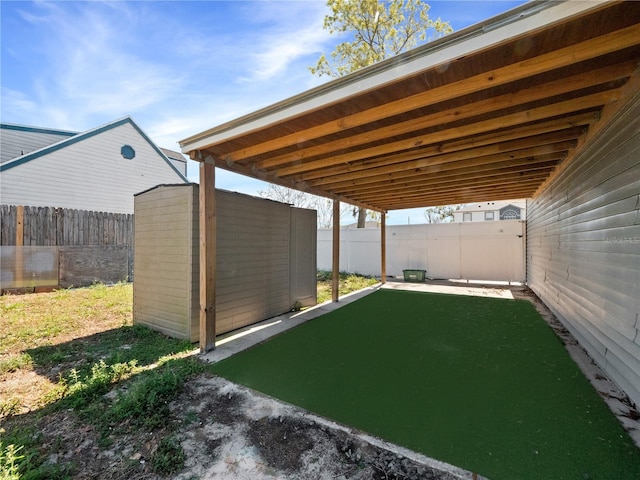 view of yard with a fenced backyard, a storage shed, and an outdoor structure