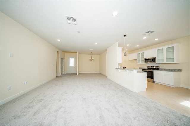 unfurnished living room with recessed lighting, arched walkways, and visible vents