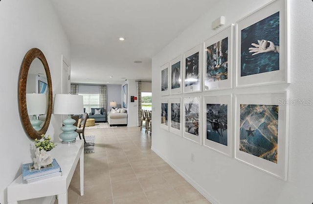 hallway with light tile patterned floors, baseboards, and recessed lighting