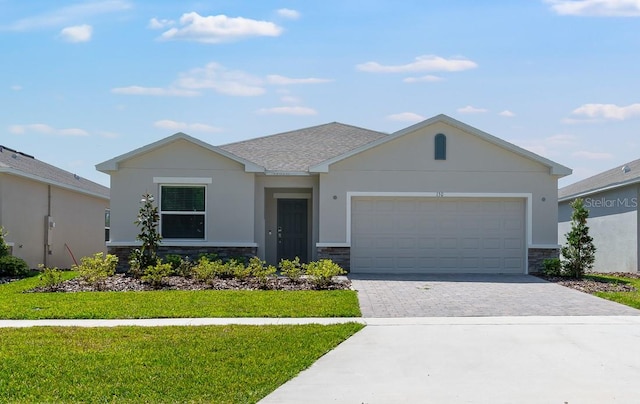 single story home featuring stucco siding, decorative driveway, stone siding, and a garage