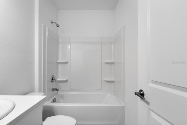 bathroom featuring bathing tub / shower combination, vanity, and toilet