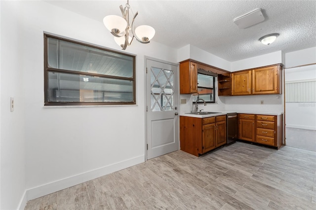 kitchen with a sink, light countertops, light wood-style flooring, brown cabinetry, and open shelves