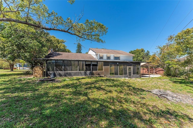 back of house with a lawn and a sunroom