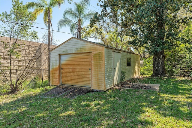 view of outbuilding with an outbuilding and fence