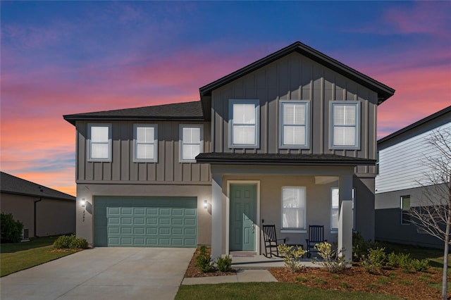 view of front of house with a porch, an attached garage, board and batten siding, and concrete driveway