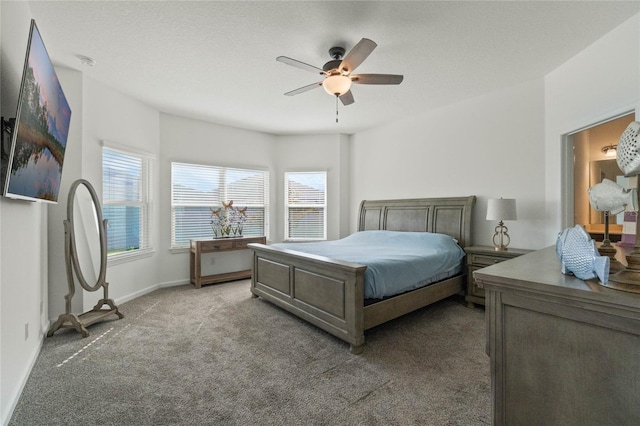 carpeted bedroom featuring a textured ceiling, baseboards, and a ceiling fan