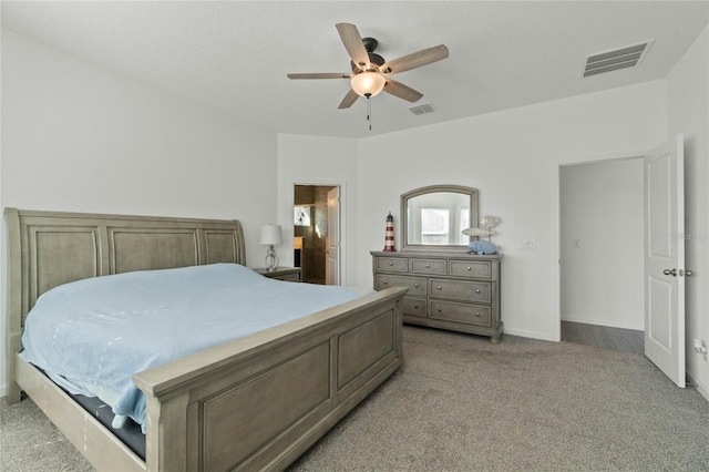 bedroom with light colored carpet, visible vents, and ceiling fan