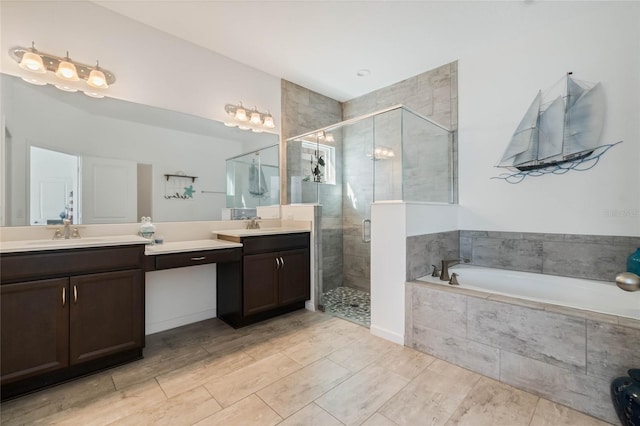 bathroom with a bath, a shower stall, and vanity