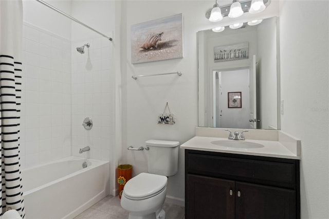 full bath featuring vanity, baseboards, tile patterned flooring, shower / tub combo, and toilet