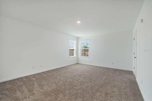 carpeted spare room with recessed lighting and baseboards