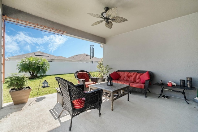 view of patio / terrace featuring a ceiling fan, an outdoor living space, and a fenced backyard