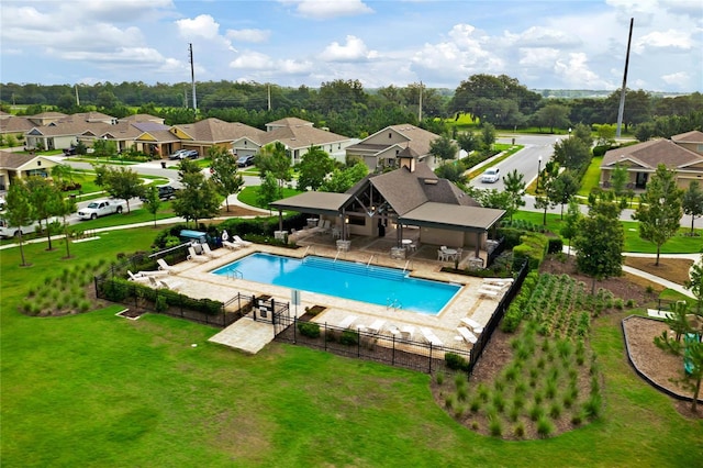 community pool featuring a gazebo, a residential view, a yard, and fence