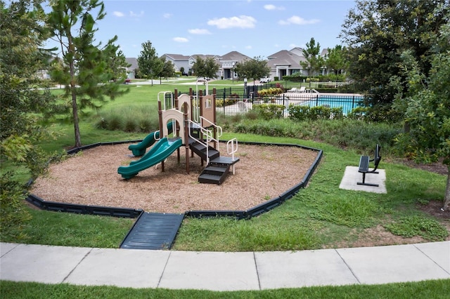 community playground with a lawn and fence