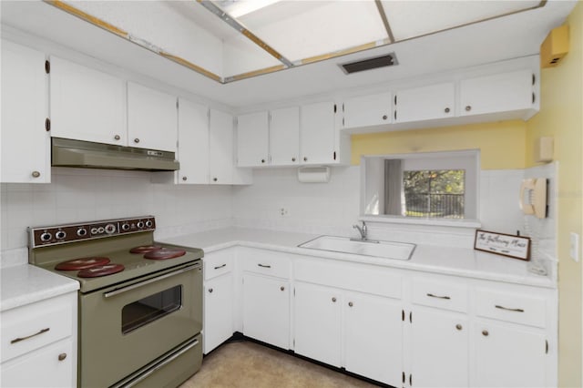 kitchen with a sink, electric range oven, light countertops, white cabinets, and under cabinet range hood