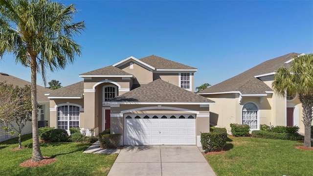 traditional home featuring stucco siding, an attached garage, driveway, and a front lawn