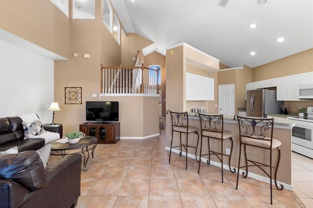 living room featuring recessed lighting, stairway, light tile patterned flooring, baseboards, and a towering ceiling