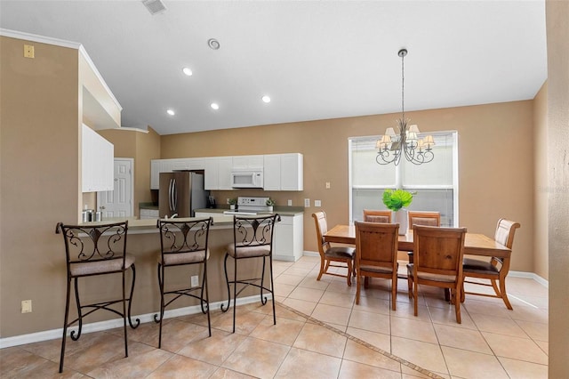 dining room featuring light tile patterned floors, baseboards, visible vents, lofted ceiling, and a chandelier