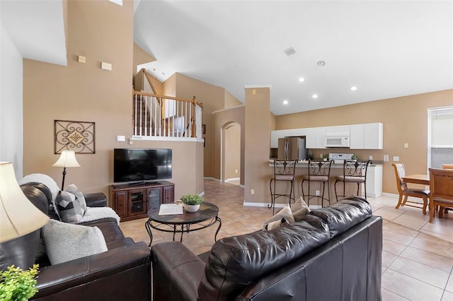 living area with visible vents, baseboards, light tile patterned flooring, recessed lighting, and vaulted ceiling