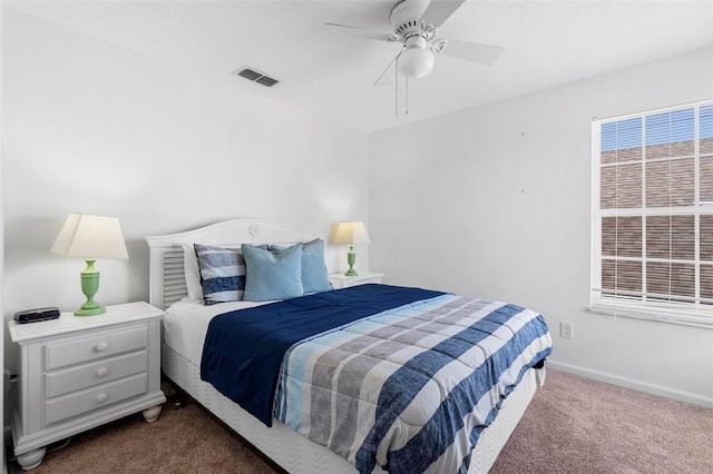 bedroom featuring visible vents, baseboards, carpet, and a ceiling fan