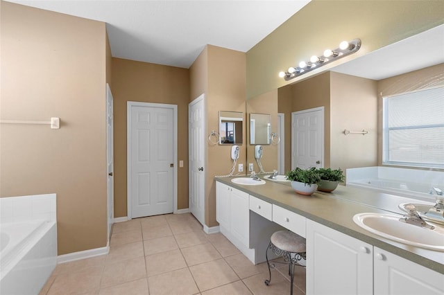 bathroom featuring a sink, a garden tub, double vanity, and tile patterned flooring