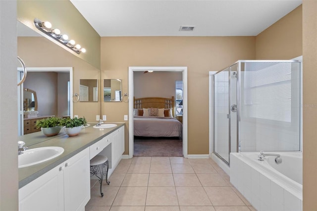 ensuite bathroom with visible vents, connected bathroom, a stall shower, and a sink