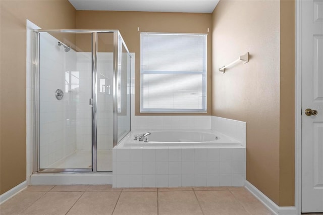 bathroom with tile patterned floors, a bath, and a shower stall