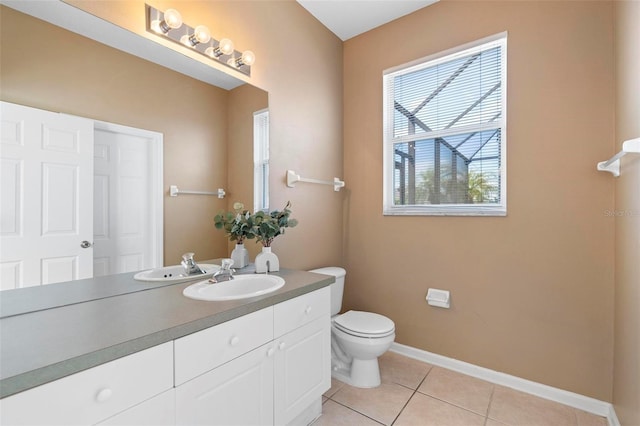 bathroom featuring tile patterned floors, toilet, vanity, and baseboards