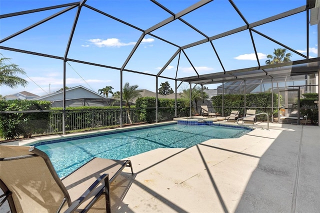 view of pool featuring a lanai, a pool with connected hot tub, and a patio