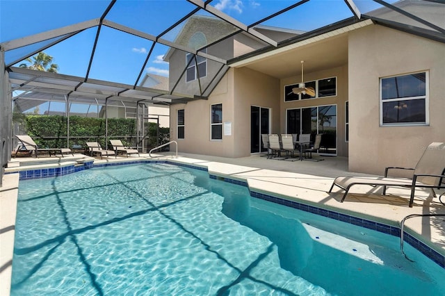 pool featuring a patio, a ceiling fan, and a lanai