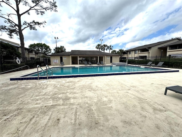 pool featuring a patio area and fence