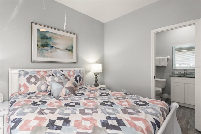 bedroom featuring a sink, wood finished floors, and ensuite bathroom