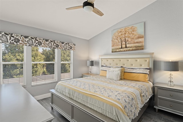 bedroom with lofted ceiling, dark wood-style floors, baseboards, and ceiling fan