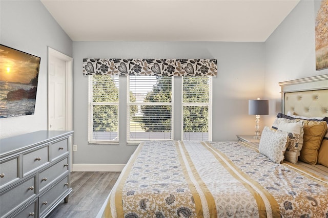 bedroom with baseboards and dark wood finished floors