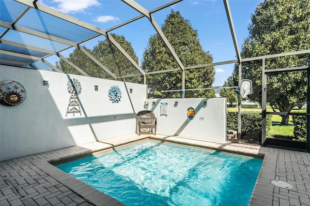 view of swimming pool with glass enclosure