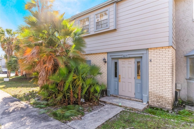 entrance to property with brick siding