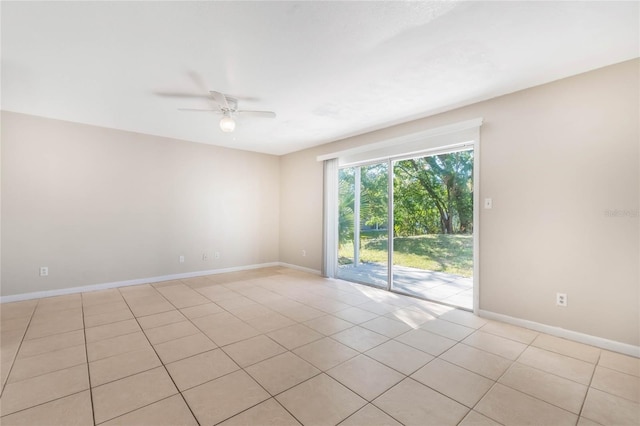 empty room featuring baseboards and ceiling fan