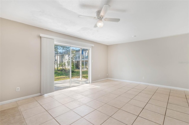 unfurnished room featuring light tile patterned floors, ceiling fan, and baseboards