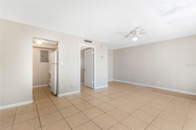 unfurnished room featuring visible vents, light tile patterned flooring, a ceiling fan, and baseboards