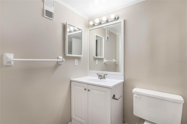 half bath featuring visible vents, toilet, vanity, and ornamental molding