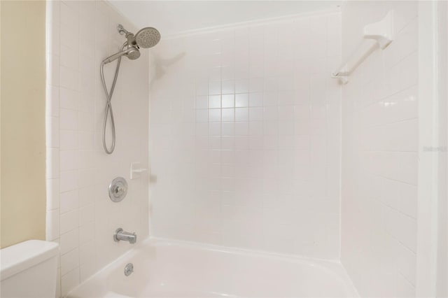 bathroom featuring toilet and tub / shower combination