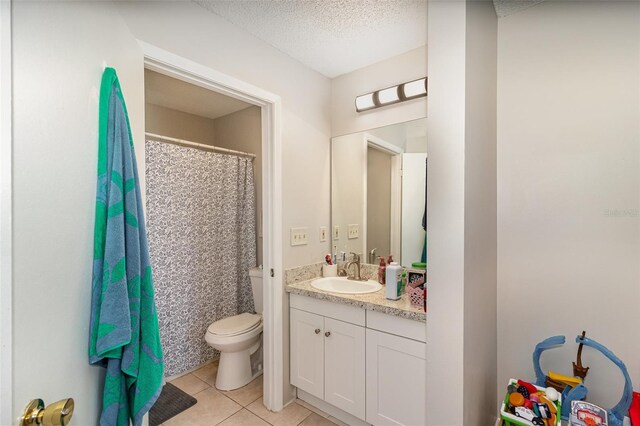 full bathroom with tile patterned floors, toilet, curtained shower, a textured ceiling, and vanity