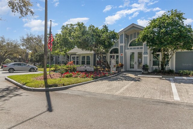 view of front of house with french doors and uncovered parking