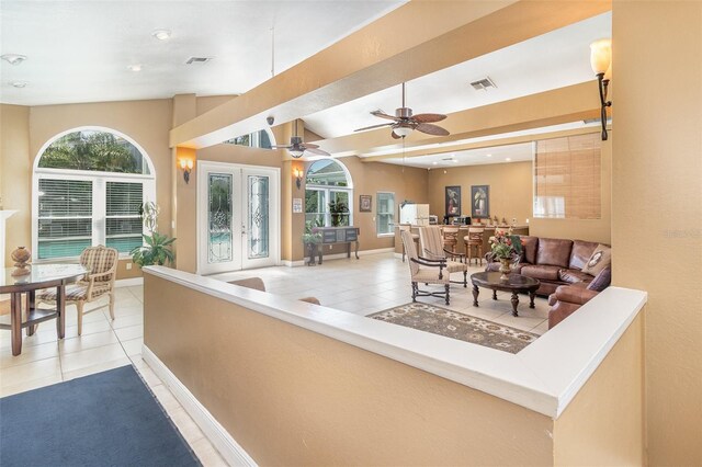 living room with light tile patterned floors, visible vents, baseboards, and french doors