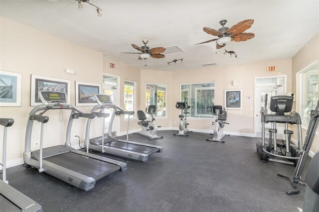 exercise room featuring baseboards and ceiling fan