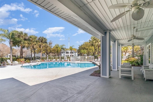 pool featuring a ceiling fan, a patio area, and fence