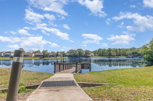 dock area featuring a yard and a water view